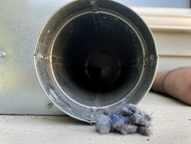 Downey Dryer Vent Cleaning technician using specialized equipment to clear severe dryer vent blockage in Downey
